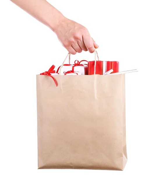 Female hand holding paper bag with present boxes — Stock Photo, Image