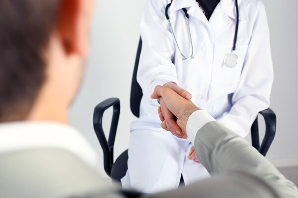 Doctor receiving patient in office