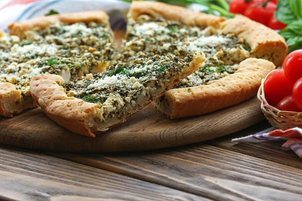 Slices of open pie with spinach and tomato cherry on table close up — Stock Photo, Image