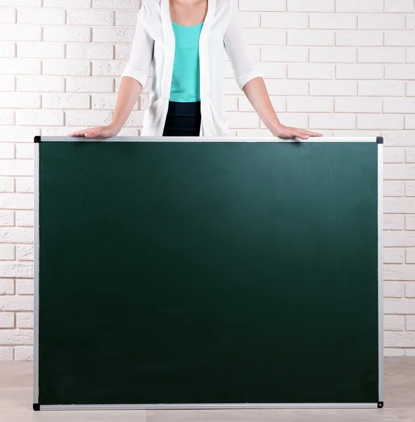 Teacher with blackboard in classroom — Stock Photo, Image