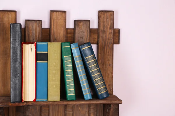 Wooden shelf with books on wall, closeup — Stock Photo, Image