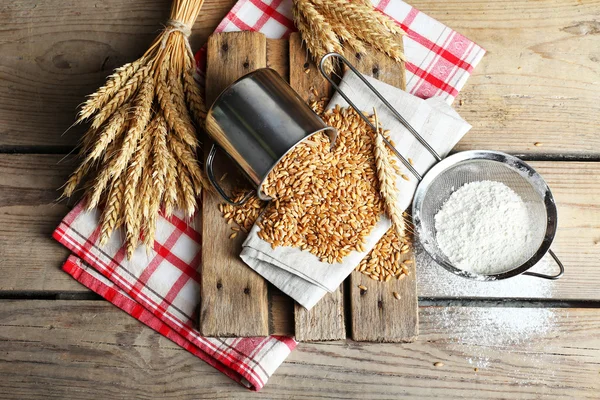 Flour and wheat on wooden table — Stock Photo, Image