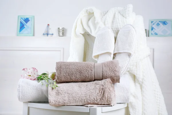 Bath set with white bathrobe on chair, indoors — Stock Photo, Image