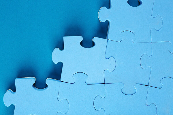 Puzzle pieces on blue background