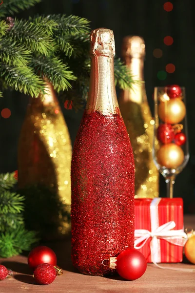 Decorative champagne bottles on wooden table, closeup Royalty Free Stock Photos