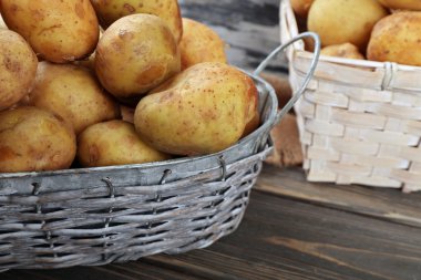 Ahşap masa hasır sepetleri genç patates yakın çekim
