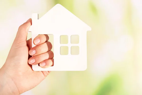 Female hand with model of house — Stock Photo, Image