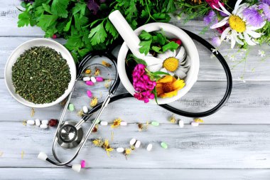 Alternative medicine herbs, berries and stethoscope clipart