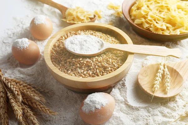 Preparing pasta with white flour and wheat on table, closeup — Stock Photo, Image