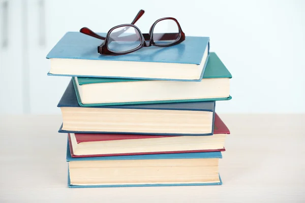 Stack of books with glasses — Stock Photo, Image