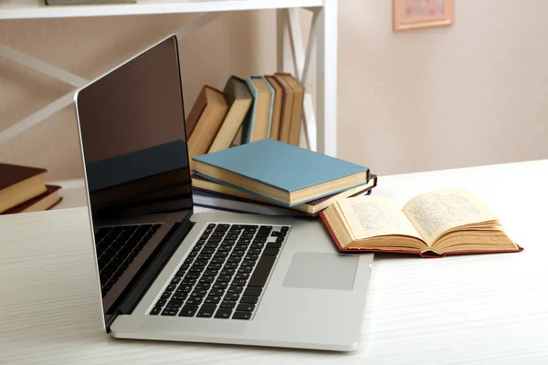 Laptop with books on table — Stock Photo, Image