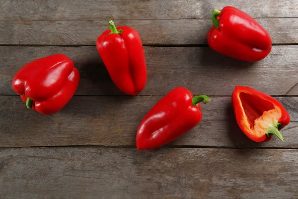 Red peppers on rustic wooden background — Stock Photo, Image