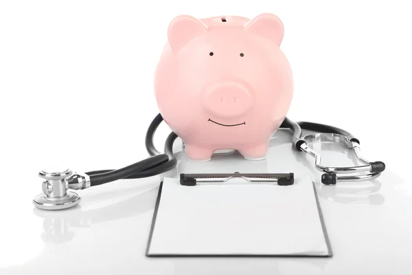 Piggy bank with stethoscope and clipboard — Stock Photo, Image