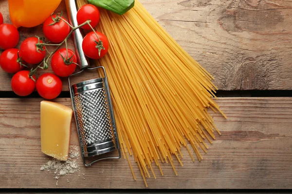 Pasta spaghetti with tomatoes, cheese and basil on rustic wooden  background — Stock Photo, Image