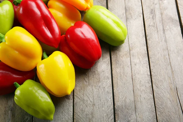 Colorful peppers on rustic wooden background — Stock Photo, Image