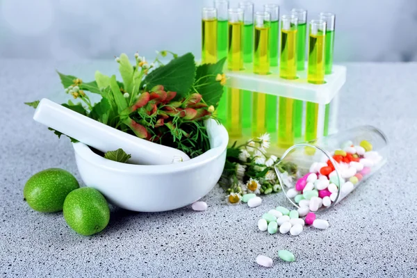 Herbs in mortar, test tubes — Stock Photo, Image