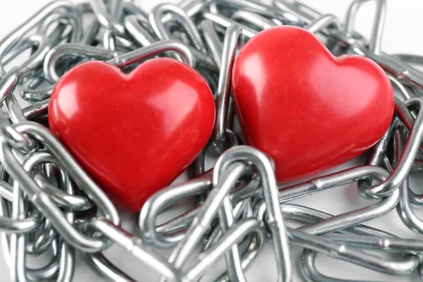 Two red hearts with metal chain — Stock Photo, Image