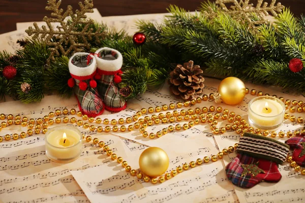 Christmas decorations on music sheets — Stock Photo, Image