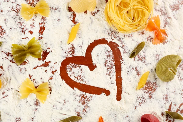 Row pasta on flour background — Stock Photo, Image