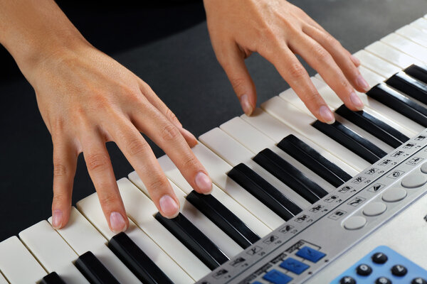 Woman playing synthesizer