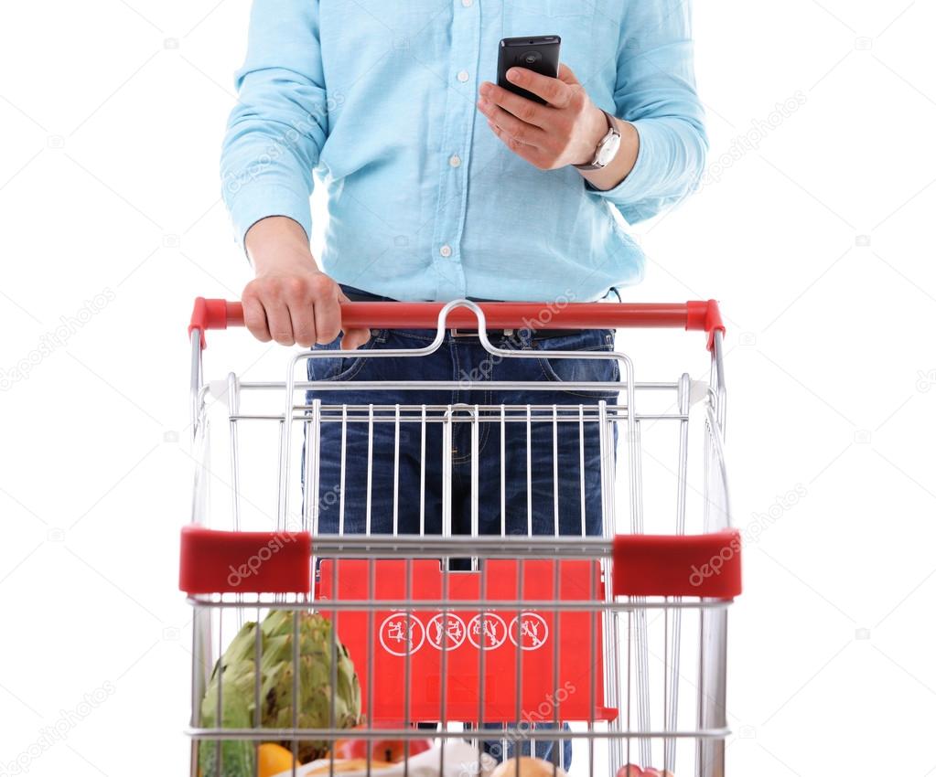 man holding  phone and shopping cart