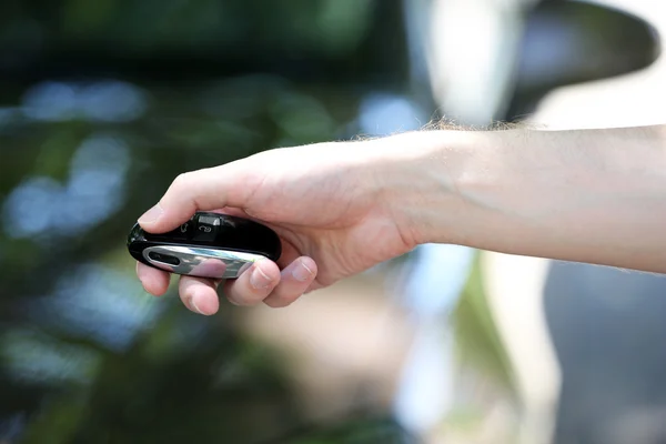 Hand presses on remote control — Stock Photo, Image