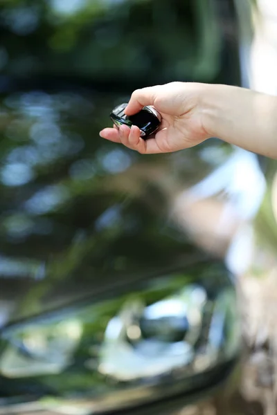 Hand presses on remote control car alarm systems — Stock Photo, Image