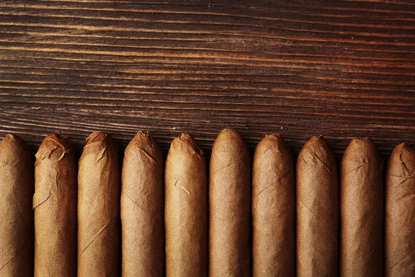 Sigaren op houten tafel, bovenaanzicht — Stockfoto