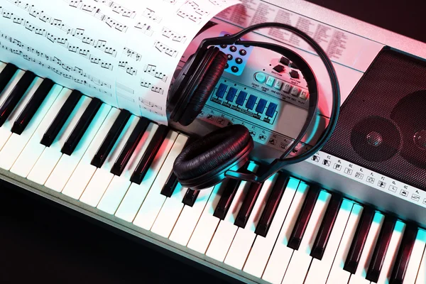 Kopfhörer mit Musiknoten auf Synthesizer — Stockfoto
