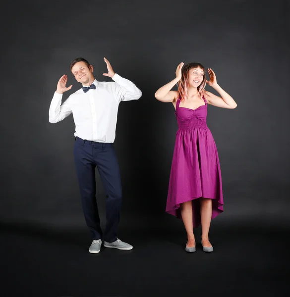 Young couple on black — Stock Photo, Image