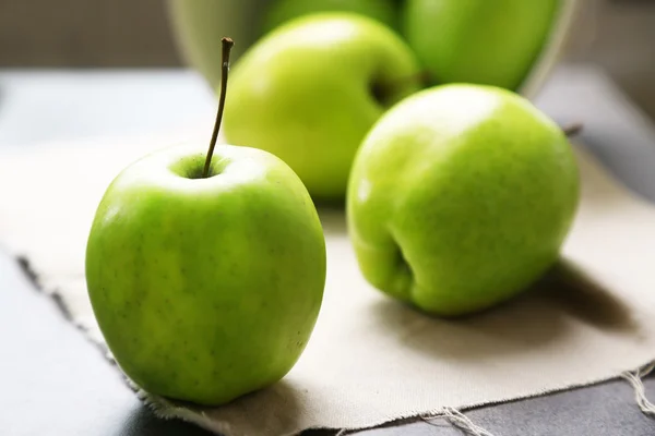 Green apples on wooden table — Stock Photo, Image