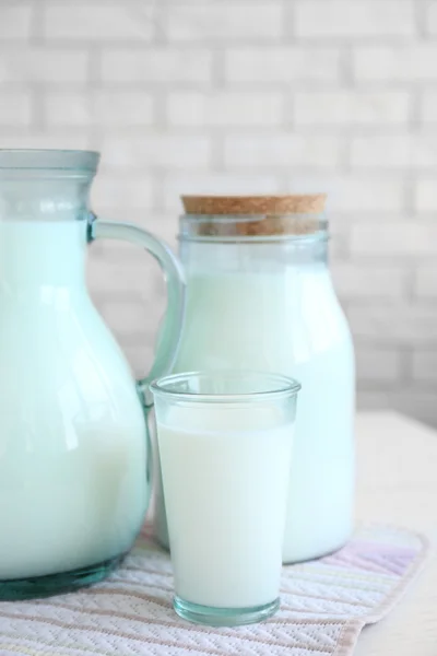 Pitcher, jar and glass of milk — Stock Photo, Image