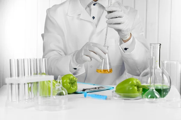 Wetenschapper onderzoekt salade peper in laboratorium — Stockfoto