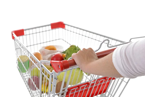 Jovem com carrinho de compras isolado em branco — Fotografia de Stock