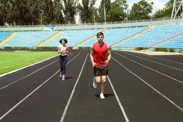 Young people jogging on stadium — Stock Photo, Image