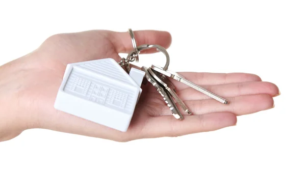 Female hand holding keys with house key chain isolated on white — Stock Photo, Image