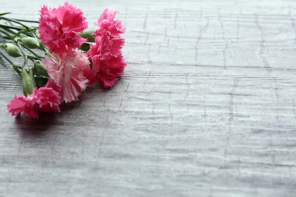 Hermosas flores silvestres pequeñas sobre fondo de madera — Foto de Stock