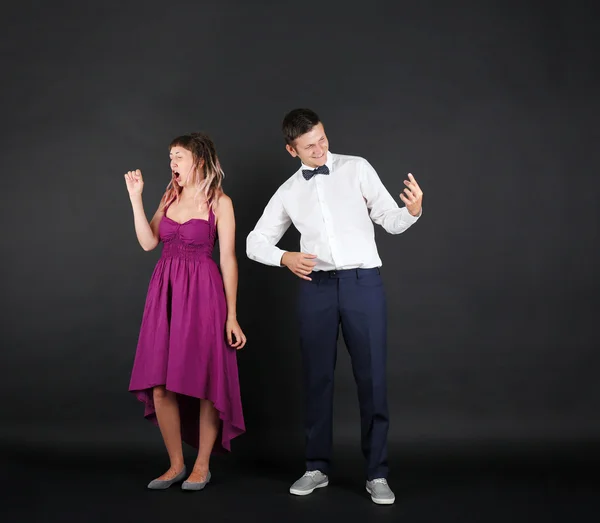 Emotional young couple on black background — Stock Photo, Image