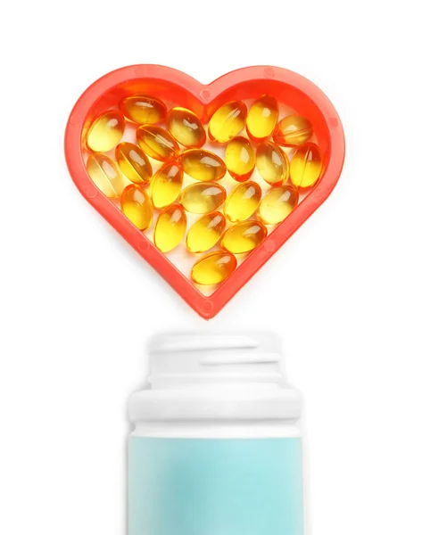 Heart of cod liver oil and jar with capsules — Stock Photo, Image