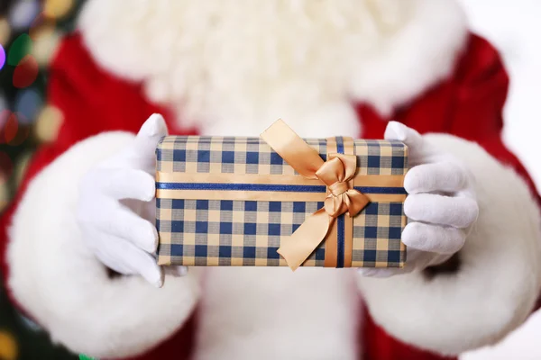 Santa holding gift — Stock Photo, Image