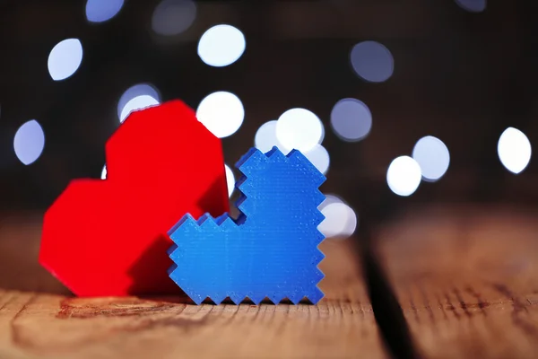 Hearts on wooden table and blurred background with lights — Stock Photo, Image