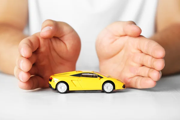 Male hands and car as protection of car concept — Stock Photo, Image