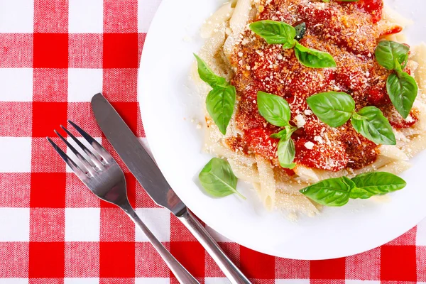 Pasta with tomato sauce and basil on table close up — Stock Photo, Image