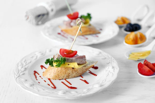 Tasty canapes on wooden table, close up — Stock Photo, Image