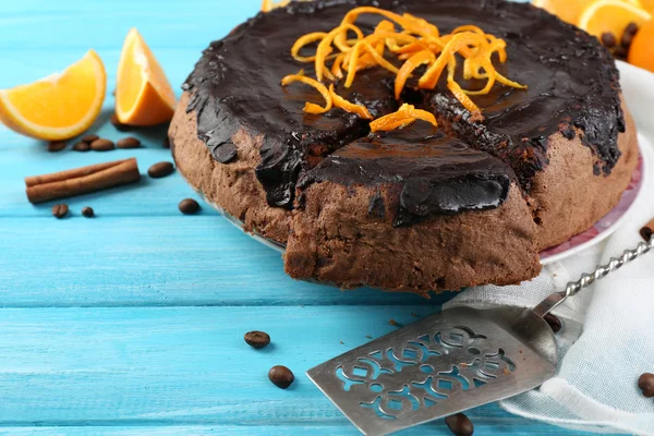 Cake with Chocolate Glaze and orange on color wooden background — Stock Photo, Image