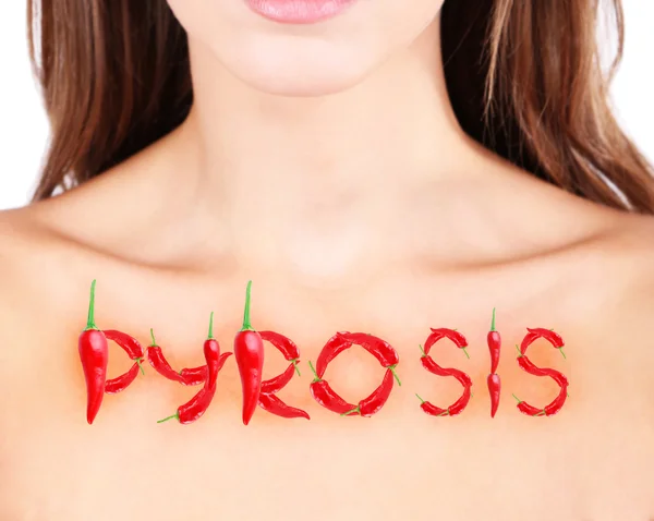 Word pyrosis made with red hot peppers on woman's body — Stock Photo, Image