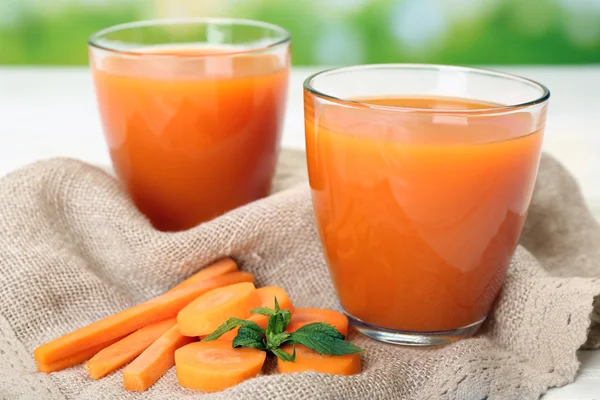 Glasses of carrot juice with vegetable slices — Stock Photo, Image