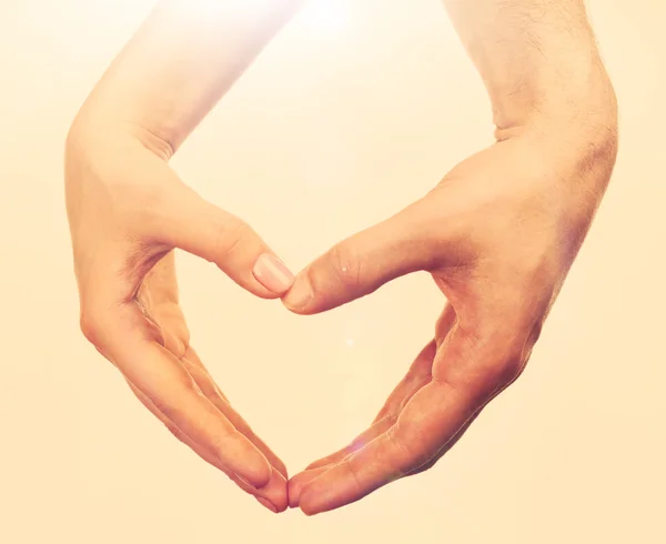 Heart shaped by male and female hands — Stock Photo, Image