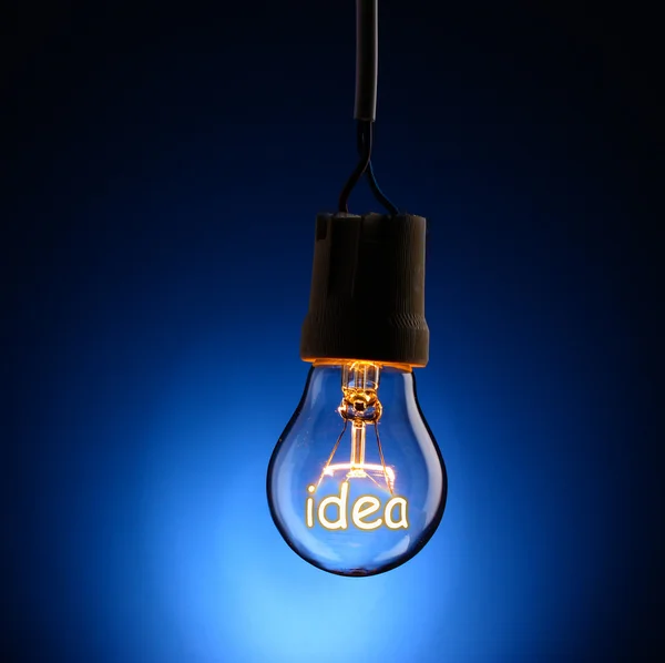 Light bulb on dark background — Stock Photo, Image