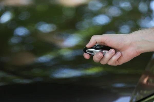 Hand presses on remote control car alarm systems — Stock Photo, Image